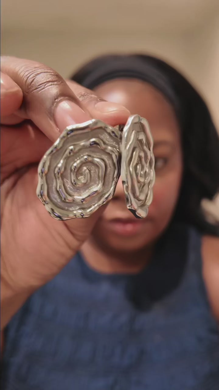 Women trying on Silver Swirl Studs 